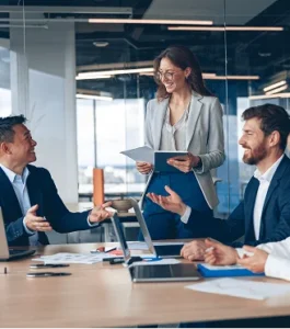 A group of colleagues seated at a table, actively participating in a business meeting
